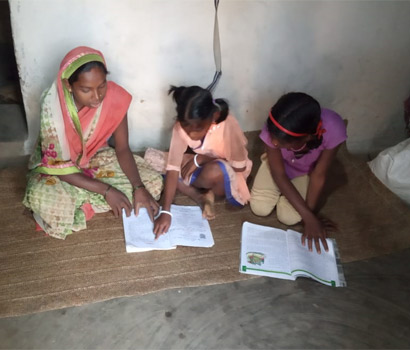 Parents and Kids learning to read in village